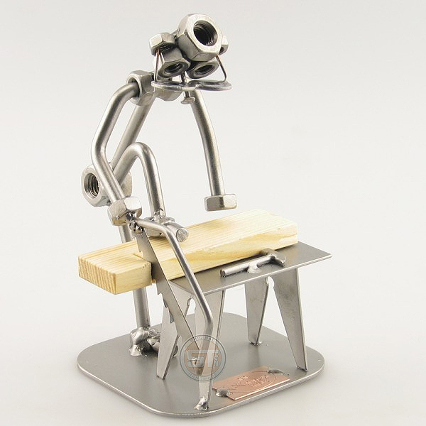 Do-It-Yourself SteelMan sawing a board metal art figurine