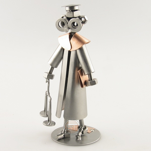 Steelman Law Graduate holding a scale metal art figurine