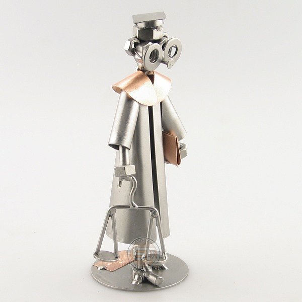 Steelman Law Graduate holding a scale metal art figurine