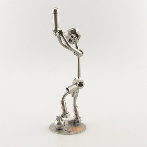 Steelman stepping on a soccer ball and holding up a trophy metal art figurine