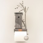 Bathroom Tissue Dispenser with a SteelMan sitting in the Restroom above reading metal art figurine