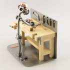 Do-It-Yourself SteelMan sawing a board metal art figurine