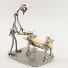 Do-It-Yourself SteelMan sawing a board metal art figurine